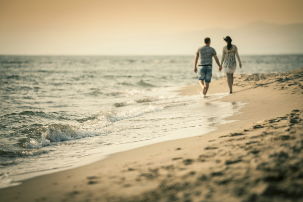 couple-holding-hands-beach.jpeg