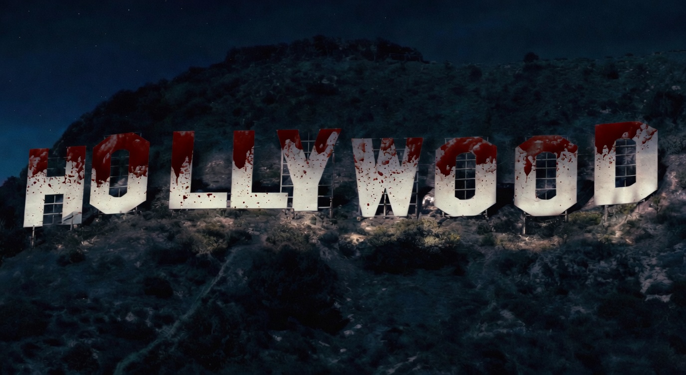 Mock photo of the iconic Hollywood sign on a dark hillside at night, with each large white letter heavily drenched and splattered in dripping blood against a starry night sky.